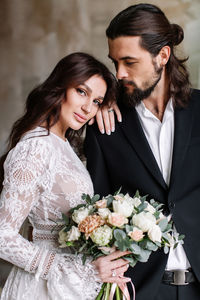 Young couple kissing on flower bouquet