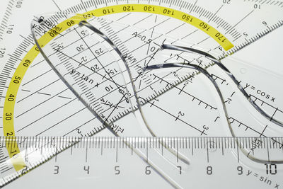 High angle view of rulers and book on table
