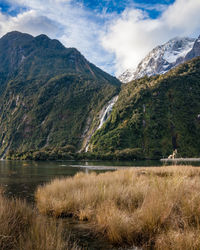 Scenic view of lake and mountains against sky