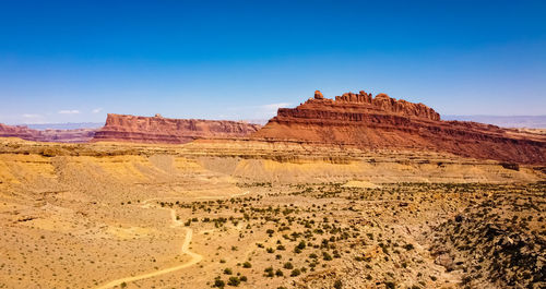 Rock formations in desert against blue sky