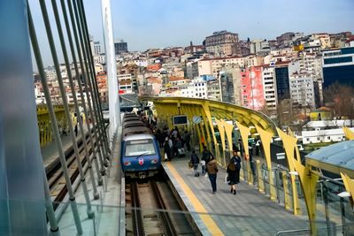 High angle view of train at railroad station against buildings in city