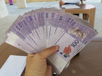 Close-up of hand holding paper