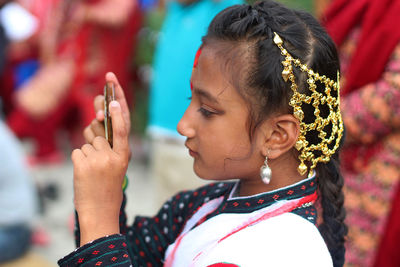 A girl dressed in traditional newari costume taking picture