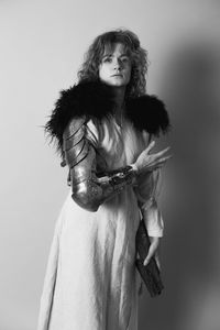 Pretty woman with metal glove in antique clothes monochrome portrait picture