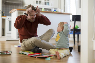 Side view of siblings playing in office