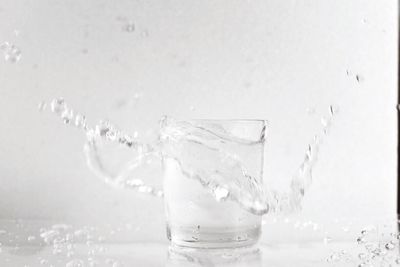 Close-up of drinking water splashing in glass