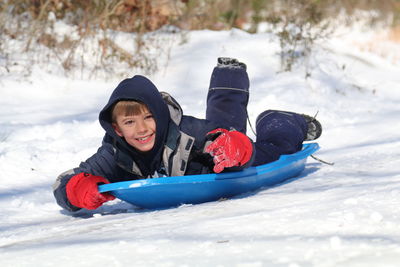 Portrait of happy boy playing in snow