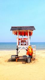 Lifeguard hut on beach against clear sky