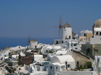 Whitewashed town against clear blue sky