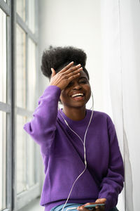 Young smiling woman sitting by window