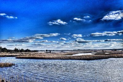 Scenic view of landscape against blue sky