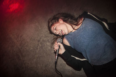 Young woman singing karaoke