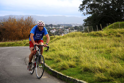 Man with bicycle on grass