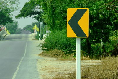 Road sign by trees