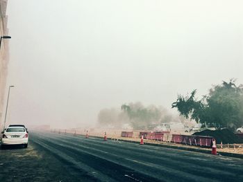 Cars on road against sky