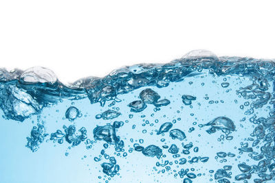 Close-up of bubbles over sea against white background