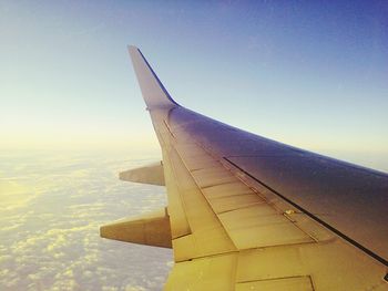 Cropped image of airplane against blue sky