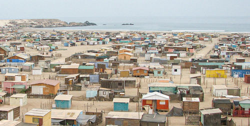 High angle view of townscape by sea against sky