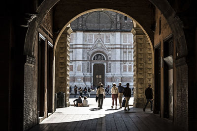 Group of people walking in historic building