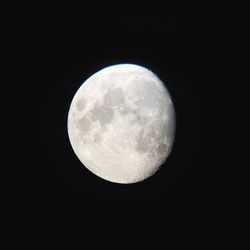 Low angle view of moon against dark sky