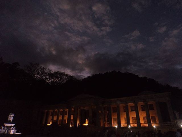 LOW ANGLE VIEW OF ILLUMINATED BUILT STRUCTURE AGAINST SKY