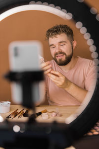 Portrait of young woman using mobile phone