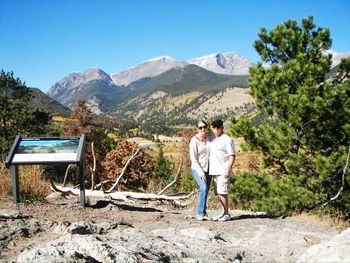 Rear view of couple standing on mountain