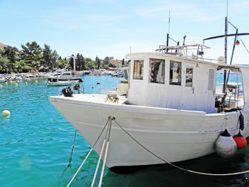 Boats moored at harbor