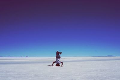 Full length of man on beach against clear sky