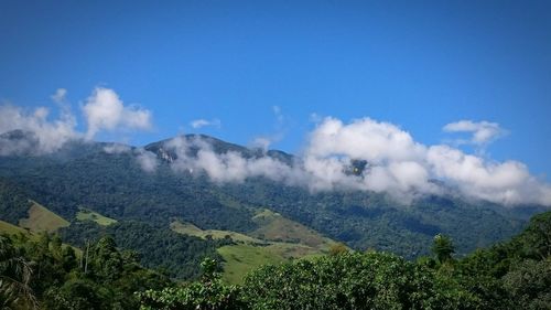 Scenic view of mountains against cloudy sky