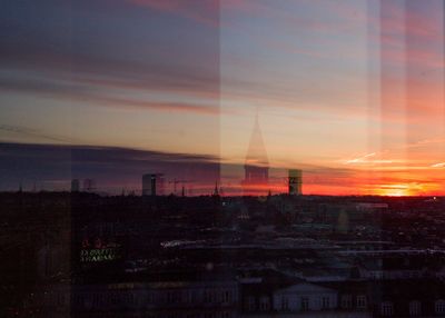Silhouette buildings against sky during sunset