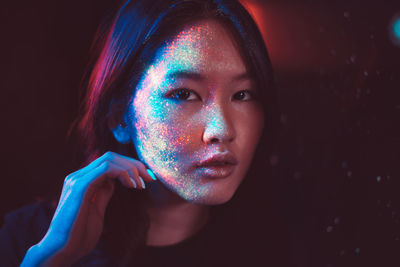 Portrait of beautiful young woman with face paint