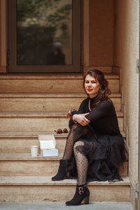 Portrait of woman sitting by window