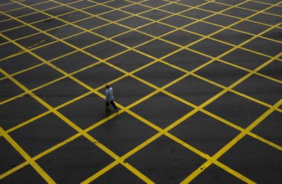 High angle view of man walking on road