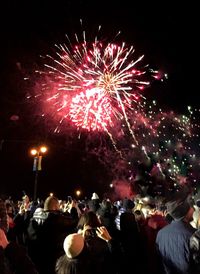 Low angle view of firework display at night