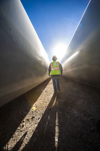 Person walks between blades at wind farm in ft. davis, texas