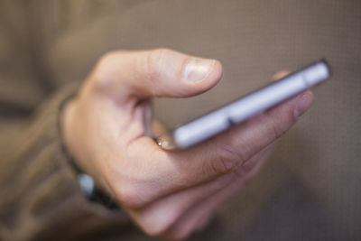 Close-up of hand holding mobile phone