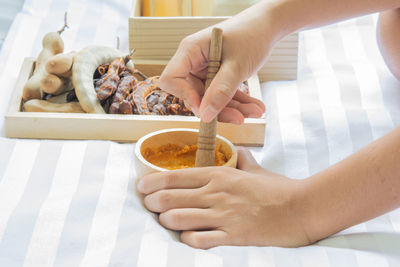 Midsection of woman preparing food