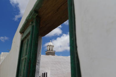 Low angle view of church and buildings against sky