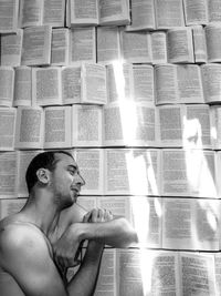 High angle view of man sleeping on books