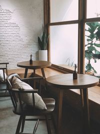 Empty chairs and table against wall at home