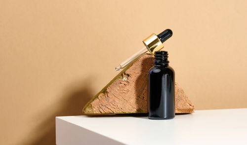 Brown glass bottle with pipette stands on a white table. cosmetics spa branding. packaging 