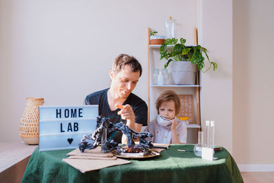 Father and son experimenting in the home laboratory and studying the chemical properties