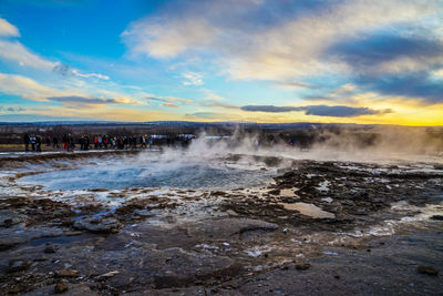 Scenic view of waterfall against sky