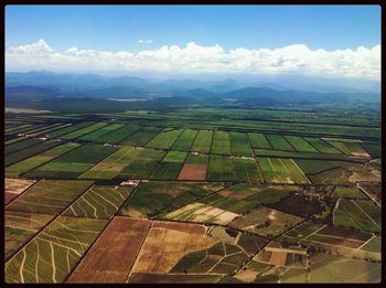 Scenic view of field against cloudy sky