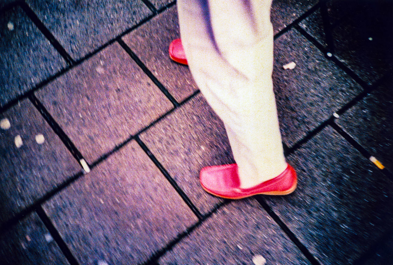 LOW SECTION OF WOMAN STANDING ON FLOOR