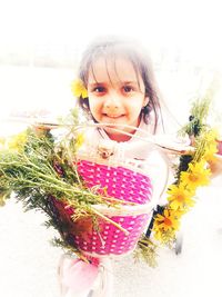 Portrait of smiling girl holding bouquet