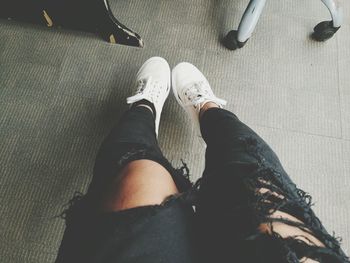 Low section of man sitting on floor