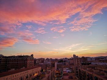 High angle view of buildings in city against sky during sunset