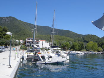 Boats in sea against clear sky